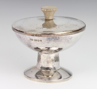 A silver hammered pattern cup and cover with fruitwood handle, the base London 1990, the lid London 1980, maker MBS, 418 grams gross, 9cm 