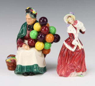 Two Royal Doulton figures -  Christmas Morn HN1992 17cm and The Old Balloon Seller HN1315 19cm 
