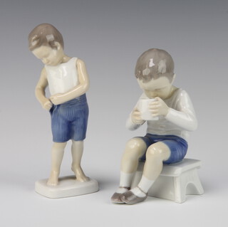 A B & G figure of a standing boy 1759 14cm, a ditto figure of a seated boy drinking from a mug 1713 13cm 