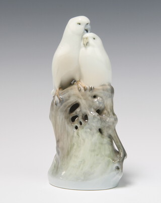 A Royal Copenhagen group of 2 budgerigars sitting on a trunk 649 18cm 