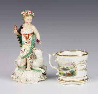 A 19th Century mug with landscape views 9cm (some wear to the gilding) and a 19th Century figure of a lady beside a camel raised on a rococo base 20cm (heavily restored) 