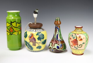 A Poole Pottery cylindrical green ground vase with stylised fruits 29cm, a Studio vase with tulip neck 23cm, a Japanese baluster vase 20cm and a Adderley ginger jar converted to electricity 17cm 