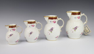 A set of 4 Coalport Caughley mask head graduated jugs decorated with flowers 18cm, 16cm, 14cm and 12cm 