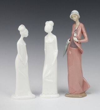 A Nao figure of a lady holding a kitten with parasol 30cm together with 2 Spode figures Henrietta 26cm and Emma 26cm designed by Pauline Shone 