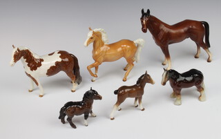 A Beswick figure of a standing piebald horse 17cm, ditto Appaloosa with raised left leg, a pottery figure of a shire horse and a pony 