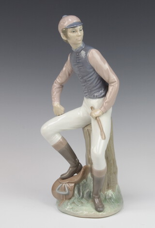 A Lladro figure of a seated jockey, base impressed 14 