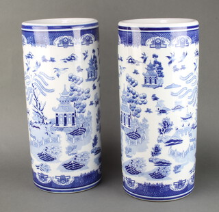 A pair of blue and white cylindrical stick stands decorated willow pattern 46cm h x 20cm diam. 