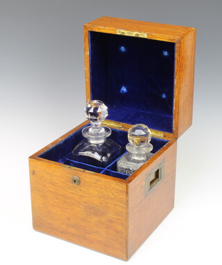 A Victorian oak 3 division decanter box with hinged lid and brass handles 28cm x 24cm x 24cm containing 2 associated square cut glass decanters and stoppers (1 chip to rim) together with a club shaped decanter and stopper 25cm 