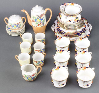A DCM Derby style 21 piece tea service comprising twin handled plate, 6 tea plates, cream jug, sugar bowl, 6 cups and 6 saucers, together with a 15 piece Japanese eggshell porcelain coffee service decorated a parrot with coffee pot, twin handled sugar bowl, cream jug, 6 coffee cans and 6 saucers 