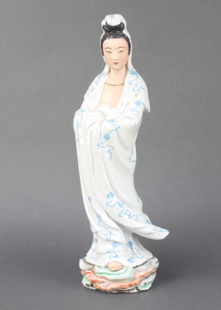 A Chinese republic figure of a standing lady raised on a rocky base with numerous impressed character marks to the base 42cm 