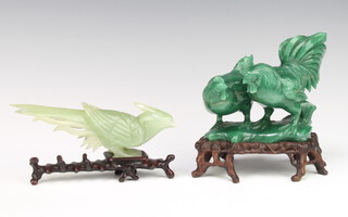 A Chinese carved hardstone group of a cockerel and a chicken raised on a hardwood base 13cm together with a hardstone figure of an exotic bird on a wooden base 16cm 