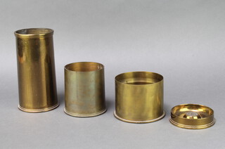 A First World War brass trench art shell case formed form an 18lb shell dated 1916, a ditto vase, cut down and marked HLF Febr 1915, 1 other marked 1939, an ashtray formed from a WW1 18lb shell case marked 1915 and two WWII 