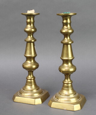 A pair of Victorian brass candlesticks with ejectors 29cm x 12cm x 12cm 