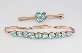A 9ct yellow gold blue topaz bracelet, bar brooch and pendant 
