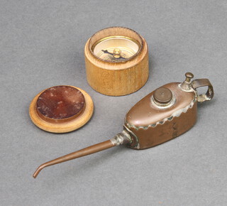 Meccano, a miniature copper oil can, the base marked Meccano K, 3cm h x 10cm w x 2cm d, together with a novelty compass contained in turned wooden case 3cm x 3cm 
