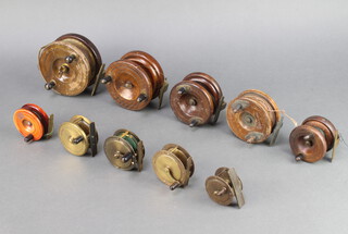 Four brass centre pin fishing reels 2 1/2" (x3) and 1 1/2" (x1), 3 brass and mahogany starback centre pin reels 4 1/2", 4" and 3 1/2" (x2) and 2 wooden centre pin fishing reels 2"