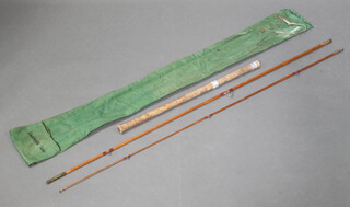 A vintage Chapmans 500 10' split can avon fishing rod with detachable butt, contained in a green cloth case 