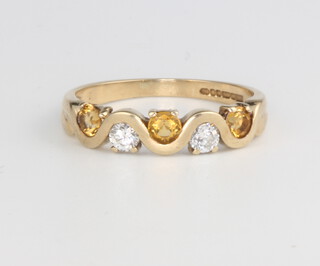A 9ct yellow gold diamond and citrine ring, the 2 brilliant cut diamonds 0.20ct, the 3 brilliant cut citrines 0.30ct, size O, 2.3 grams 