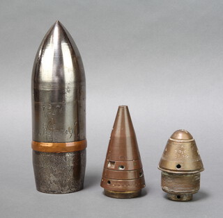 A shell nose cone 23cm x 6cm together with a brass and copper nose cone 9cm x 5cm, 12cm x 5cm 