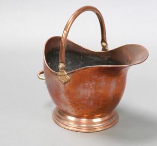 A Victorian copper helmet shaped coal scuttle with swing handle 30cm x 41cm x 26cm 