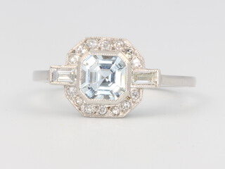 A platinum, aquamarine and diamond Art Deco style ring, the centre stone approx. 0.7ct surrounded by brilliant and baguette cut diamonds approx. 0.3ct, 4.2 grams, size P 