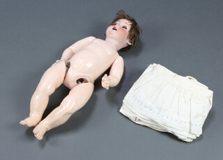 Thuringia, a porcelain headed doll with sleep eyes and open mouth, articulated body 51cm overall, head impressed Thuringia together with dolls clothes 