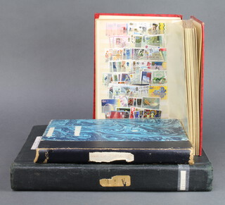 A stock book of Victorian and later used stamps including penny reds, a red stock book of used GB stamps QEII  together with a stock book of world stamps 