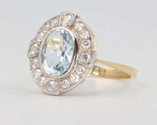 A yellow gold oval aquamarine and diamond cluster ring, the centre stone 2.25ct surrounded by brilliant cut diamonds 0.4ct, 3.6 grams, size N 