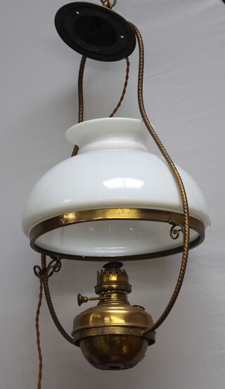 A brass and glass hanging oil lamp with opaque glass shade converted to electricity 67cm h x 37cm w