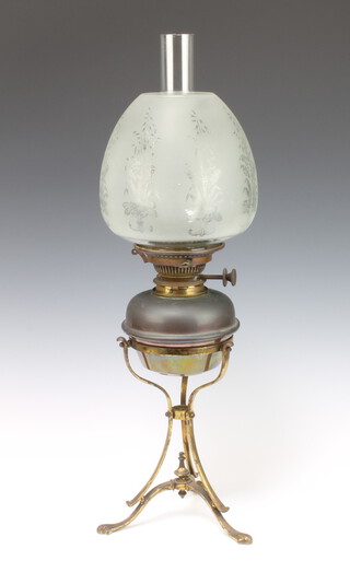 An Edwardian copper oil lamp raised on a gilt metal base with etched glass shade and glass chimney 62cm h x 17cm diam.
