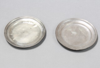 A pair of 18th Century pewter plates, the reverse with 3 touch marks 23cm diam.
