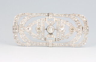 An 18ct white gold Art Deco diamond brooch set with 5 graduated old cut diamonds and rose cut diamonds, approx. 2.5ct. 55mm x 25mm, 12.5 grams