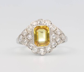 A platinum, yellow sapphire and diamond cluster ring, the centre stone approx. 1.4ct, surrounded by brilliant cut diamonds approx. 0.65ct, 4.3 grams, size N 1/2 