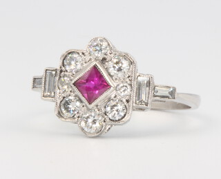 A platinum, ruby and diamond Art Deco style cluster ring, the centre stone approx. 0.3ct, surrounded by brilliant and baguette cut diamonds approx. 0.65ct, 3.4 grams, size M 1/2