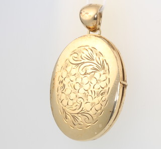 A 9ct yellow gold engraved oval locket, gross 12 grams 