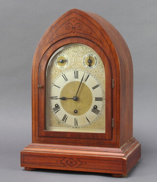 An early 20th Century German striking on gong bracket clock, the 20cm arched dial with Roman numerals, slow/fast dial, chime/silent indicator, contained in an inlaid mahogany lancet case 42cm h x 28cm w x 18cm d (no pendulum)
