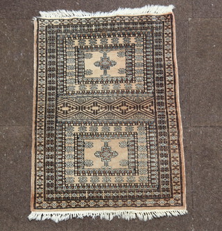 A white and black ground Bokhara rug, 2 panels to the centre within a multirow border 88cm x 62cm 