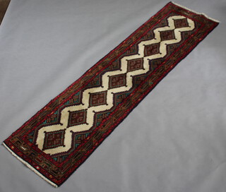 A white, blue and green ground Persian runner with 8 stylised diamonds to the centre within a 3 row border 287cm x 75cm 