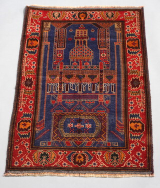 A blue and brown ground Belouche prayer rug with temple design to the centre 140cm x 92cm 