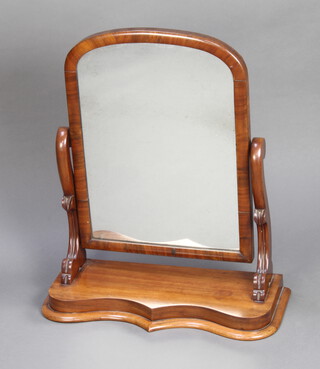 A Victorian arched plate dressing table mirror contained in a mahogany swing frame on a serpentine base, raised on scrolled supports 72cm h x 59cm w x 24cm d 