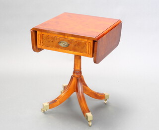 A Georgian style crossbanded yew pedestal drop flap occasional table fitted a frieze drawer, raised on turned column and tripod supports, brass caps and casters 64cm h x 46cm w x 43cm when closed x 77cm l when open 