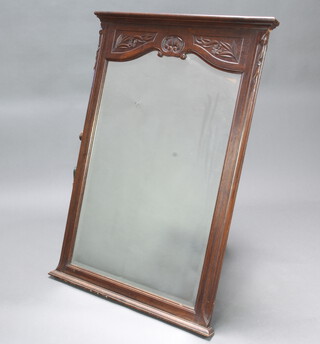 A 19th Century French arched bevelled plate over mantel mirror contained in a carved oak frame 123cm h x 83cm w 