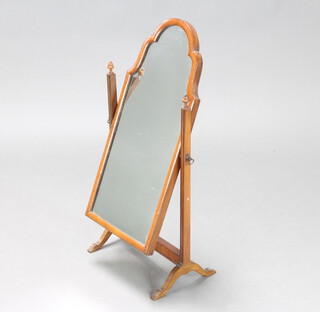 A 1930's Queen Anne style arched plate dressing table mirror contained in a walnut swing frame 64cm h x 23cm w x 33cm d 