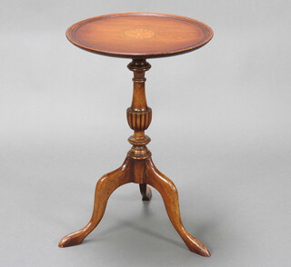 A circular Georgian style inlaid mahogany wine table raised on turned pillar and tripod base 56cm h x 37cm diam.  