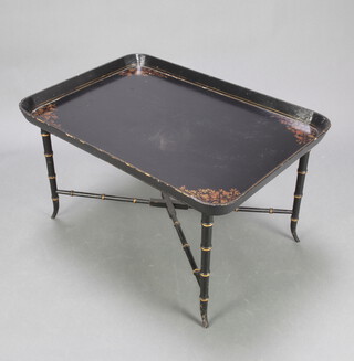 A 19th Century style rectangular lacquered tray raised on a black and gilt painted  bamboo effect base with X framed stretcher 50cm h x 82cm w x 58cm d 