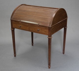 A Georgian style mahogany cylinder bureau the domed top with tambour shutter, interior fitted pigeons holes and shelves, the base with brushing/writing slide above 2 drawers, raised on square tapered supports, spade feet 91cm h x 67cm w x 63cm d 
