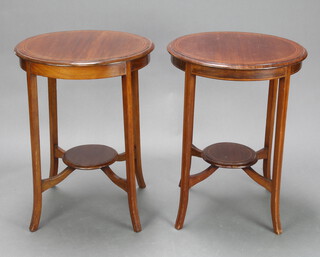 A pair of Edwardian circular inlaid mahogany 2 tier occasional tables raised on outswept supports 71cm h x 55cm diam. 