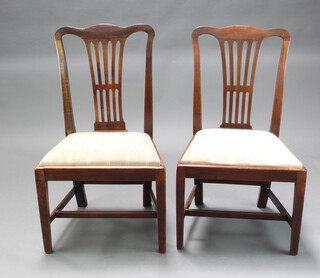 A pair of 19th Century mahogany Hepplewhite style camel back dining chairs with upholstered drop in seats raised on square supports 92cm h x 54cm w x 42cm d (seat 33cm x 33cm)  
