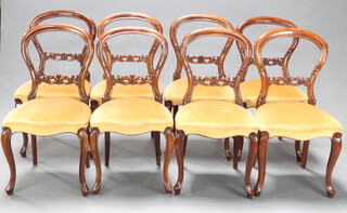 A set of 8 Victorian style mahogany balloon back dining chairs with carved and pierced mid rails and overstuffed seats, raised on French cabriole supports 89cm h x 46cm w x 42cm d (seat 33cm x 35cm) 