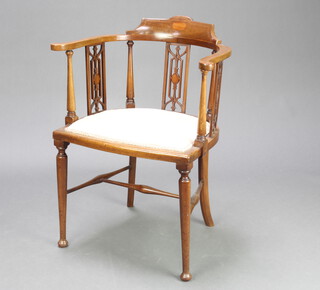 An Edwardian inlaid mahogany tub back chair with pierced panelled slat back and upholstered seat, raised on turned supports 79cm h x 59cm w x 44cm d (seat 41cm x 35cm)